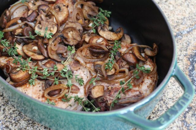 braised pork chops with mushrooms in a dutch oven