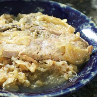 Pork chops with sauerkraut on a plate.