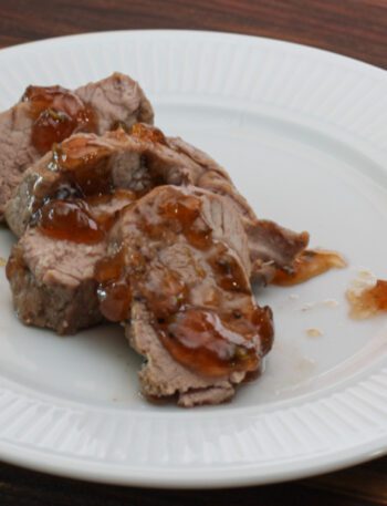 roasted pork tenderloin with jalapeño pepper glaze on a plate, sliced
