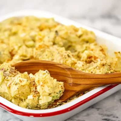 Creamy potato salad with chopped eggs and herbs.