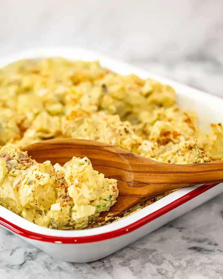 Creamy potato salad with chopped eggs and herbs.