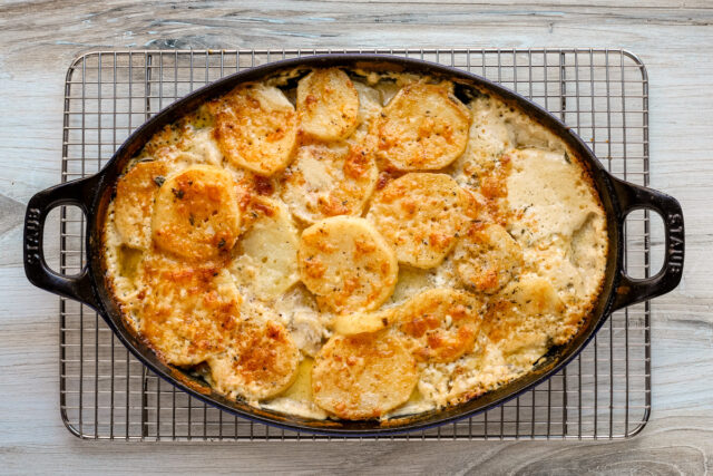 Baked potato gratin with caramelized onions, Gruyere cheese, and Parmesan.