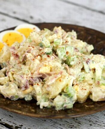 buttermilk potato salad on a plate with extra sliced hard boiled eggs.