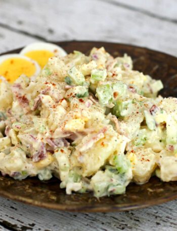 buttermilk potato salad on a plate with extra sliced hard boiled eggs.