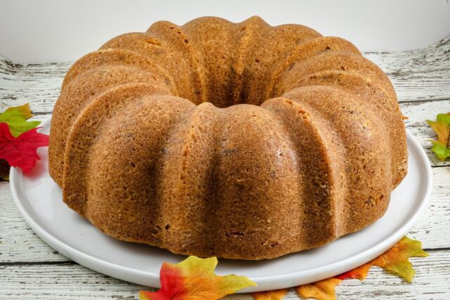 A brown sugar and pecan pound cake on a cake platter.