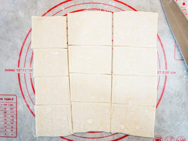 Cut the 2 sheets of puff pastry into 24 squares.