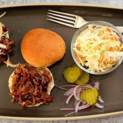 pulled pork sandwiches with coleslaw on the side