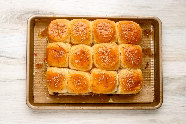 The tops of the buns are brushed with a mixture of butter, Worcestershire sauce, onion powder, and sesame seeds.