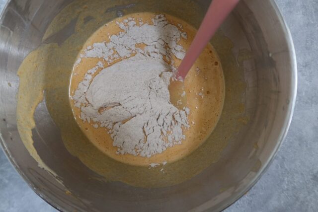 Making the batter for a pumpkin roll cake.