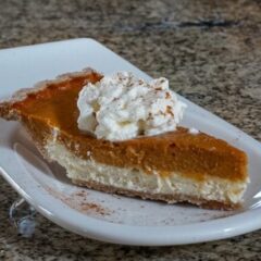 pumpkin pie with cream cheese layer on a dessert plate
