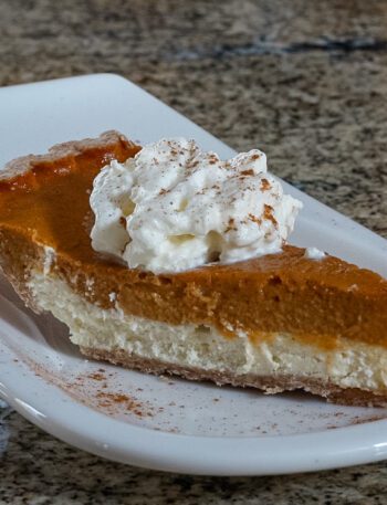 pumpkin pie with cream cheese layer on a dessert plate