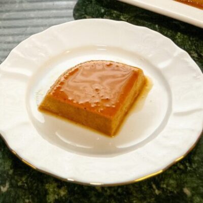 A slice of pumpkin flan on a dessert plate