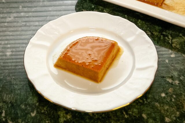 A slice of pumpkin flan on a dessert plate