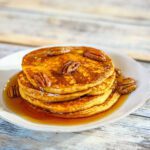 pumpkin pancakes with maple syrup and toasted pecans