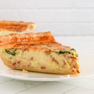 A slice of quiche lorraine on a plate
