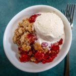 easy cherry crisp with ice cream in a dessert dish