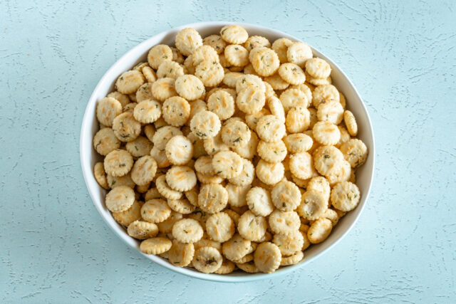 Oyster crackers with ranch dressing and dill in a large serving bowl.