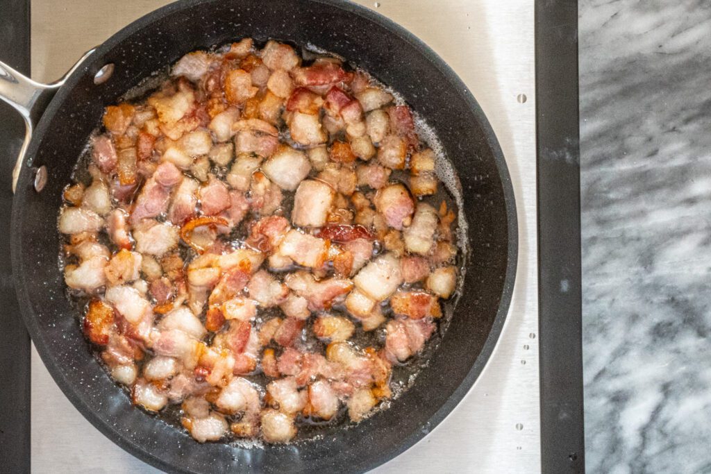 bacon sizzling in a skillet