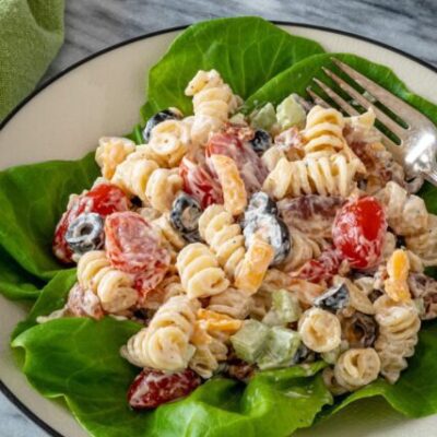 Ranch pasta salad served on a plate with lettuce leaves