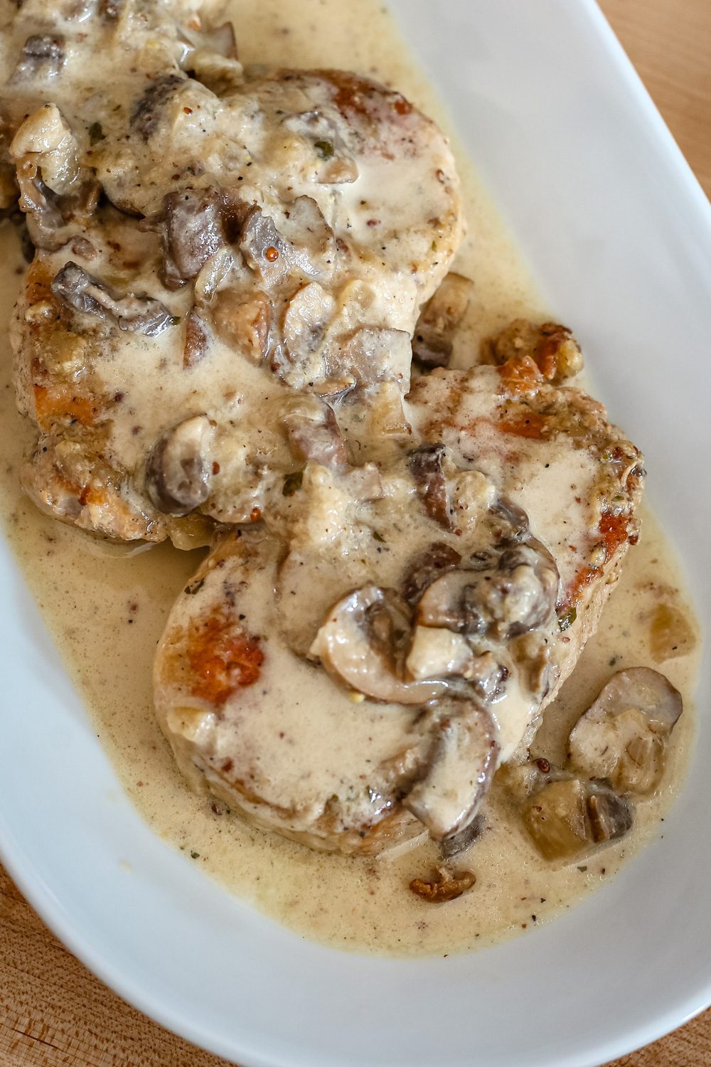 ranch pork chops with sauce on a platter