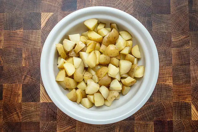Cooked cut-up potatoes in a bowl.