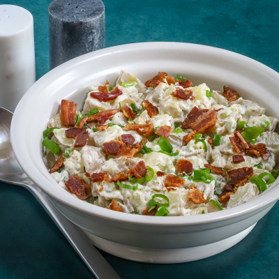 Creamy potato salad with bacon and green onions.