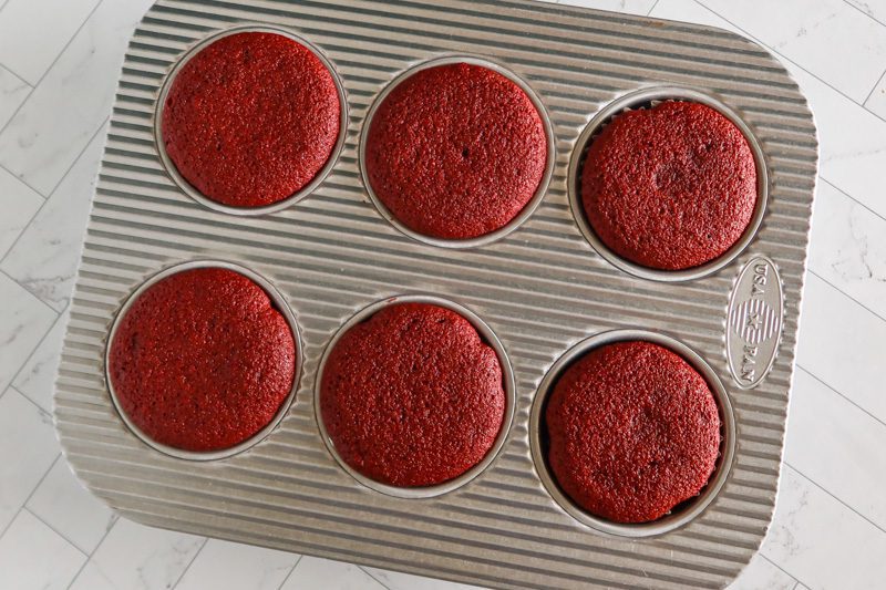 muffin tin with red velvet cupcakes baked