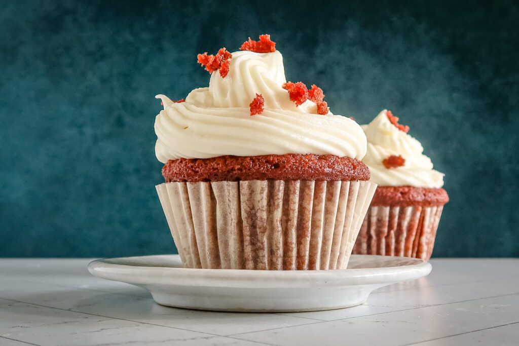 red velvet cupcakes with frosting and bits of cake
