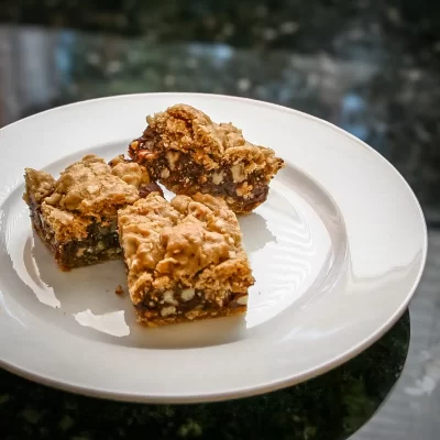 Chewy oatmeal raisin bars with chunks of nuts and dried fruit.