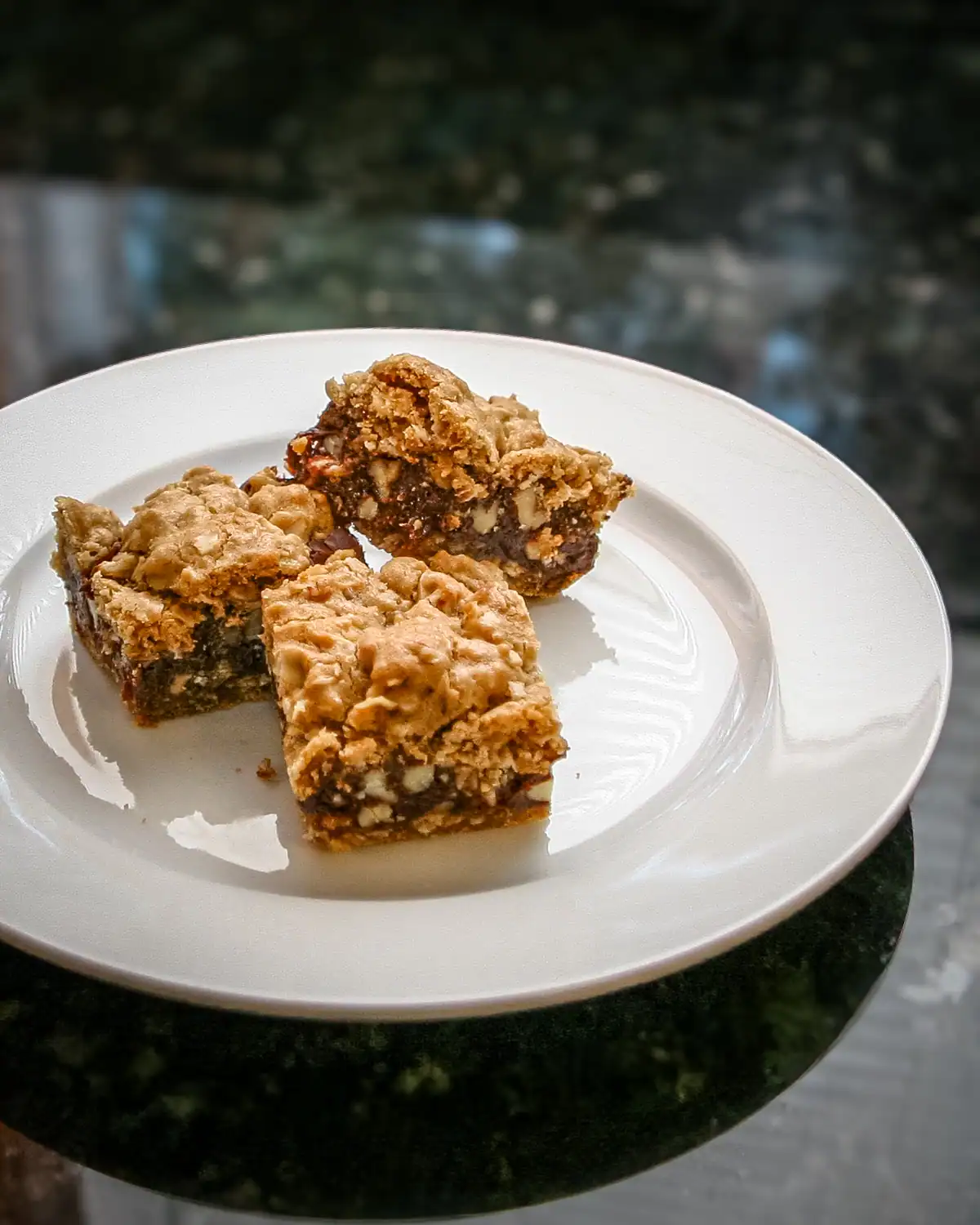 Chewy oatmeal raisin bars with chunks of nuts and dried fruit.