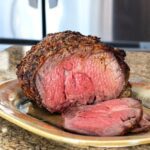 Juicy, perfectly cooked beef tenderloin roast with a seasoned crust.