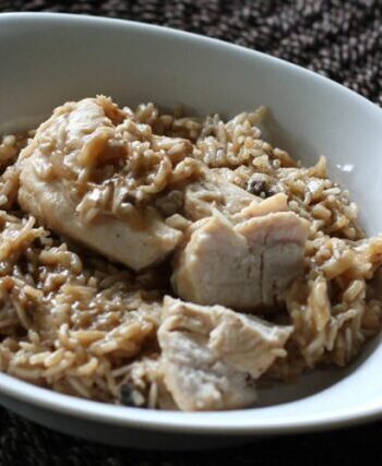 Baked rice with almonds in a dish with chicken.