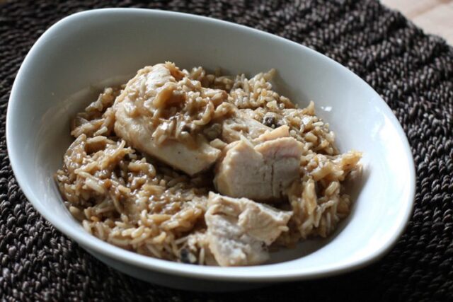 Baked rice with almonds in a dish with chicken.