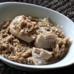 Baked rice with almonds in a dish with chicken.