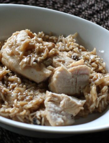 Baked rice with almonds in a dish with chicken.