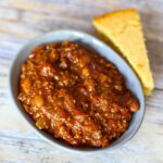 bowl of slow cooker chili with cornbread