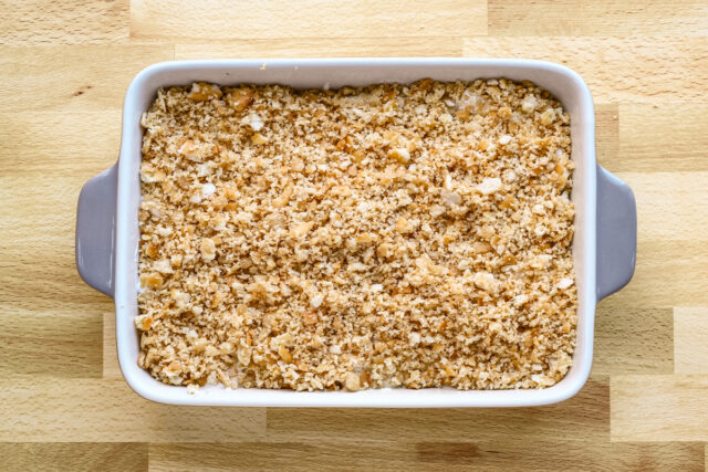 Crushed Ritz crackers spread over the top of the oven-ready chicken casserole.