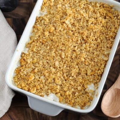 A baked Ritz chicken casserole with serving spoon, ready to enjoy!