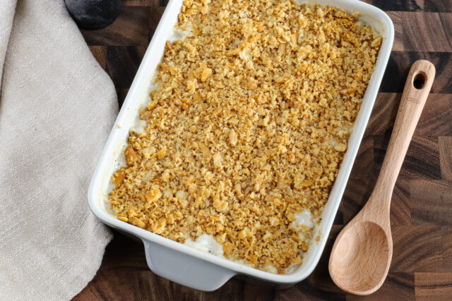 A baked Ritz chicken casserole with serving spoon, ready to enjoy!