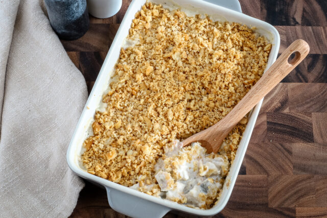 Serving up a baked Ritz chicken casserole with serving spoon.