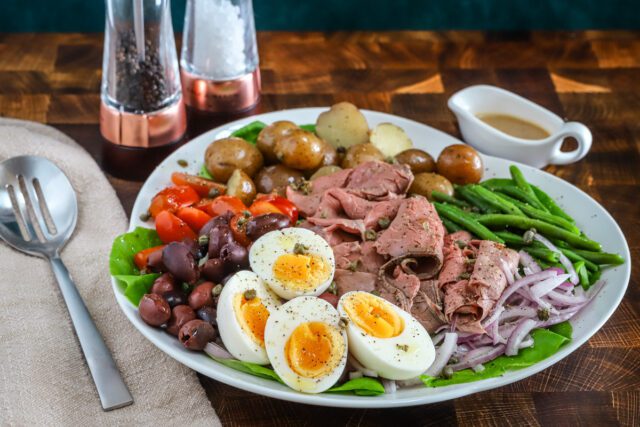 A flavorful composed Nicoise salad made with deli sliced roast beef and traditional Nicoise ingredients, finished with a Dijon dressing.