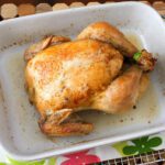 whole roasted chicken in a baking dish