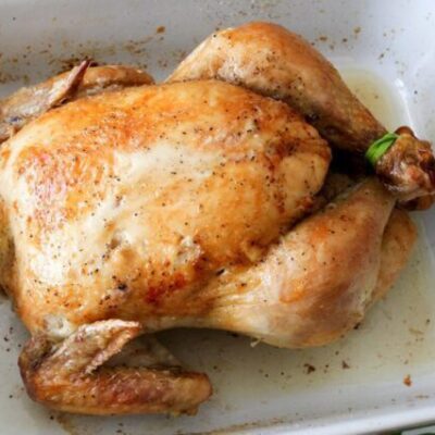 baking dish with a whole roasted chicken