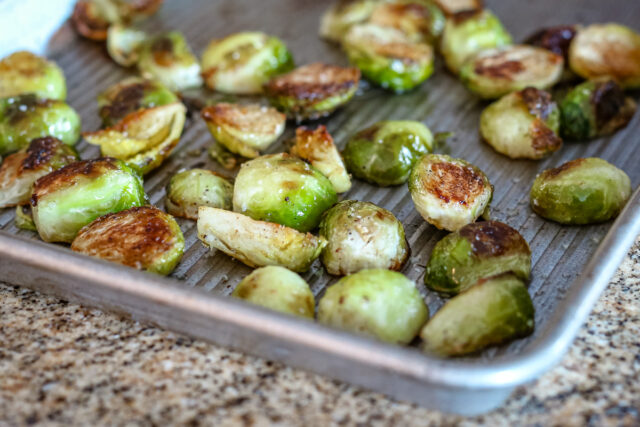 Roasted Brussels sprouts on a baking sheet.