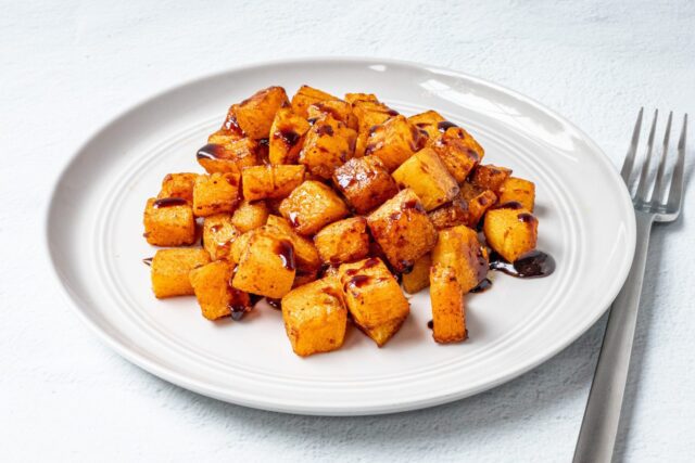 butternut squash on a plate with balsamic glaze