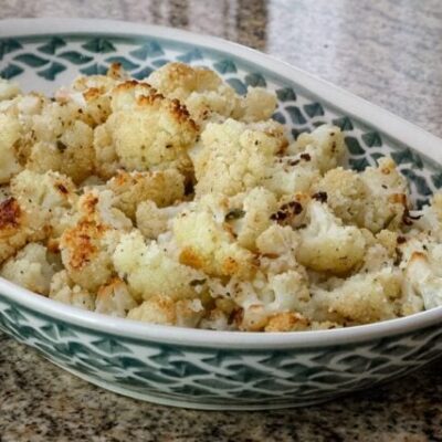 roasted cauliflower with lemon in a serving dish