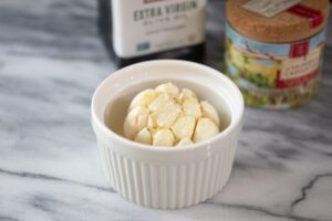 Roasted garlic prep in a ramekin.