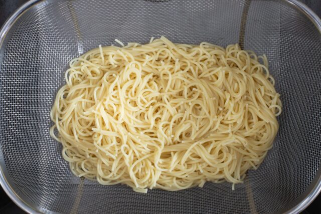 Draining spaghetti.