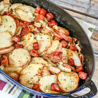 Roasted potatoes and ham in a baking dish.