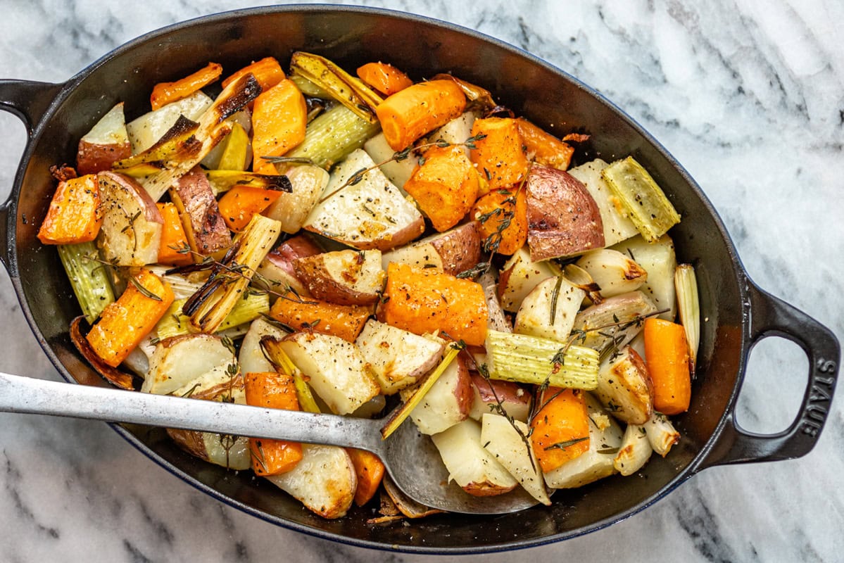 A baking dish with an assortment of roasted root vegetables.